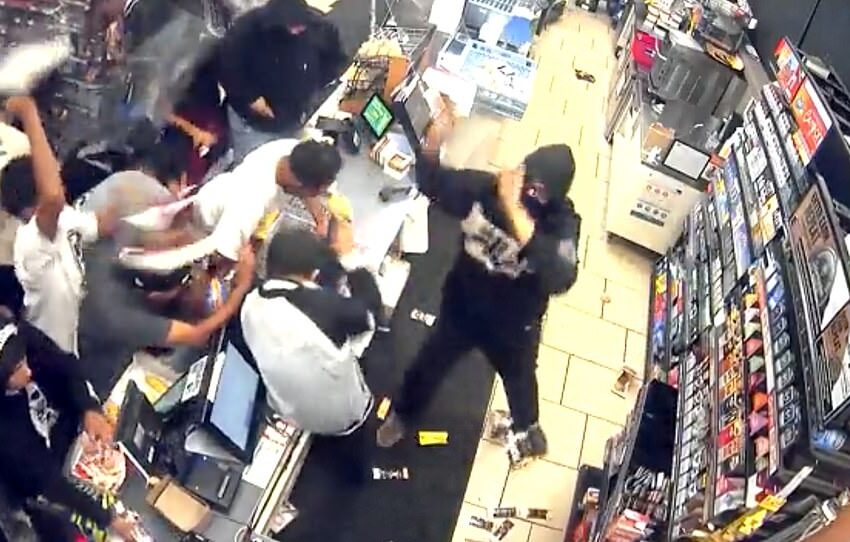  Shocking moment giant flash mob ransacks and loots 7-Eleven store in LA