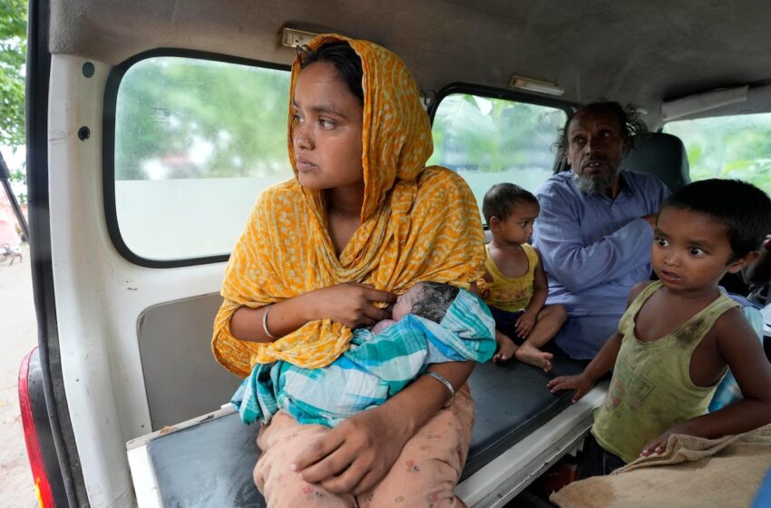  Indian mother delivers baby on boat as her river island is inundated by floodwaters